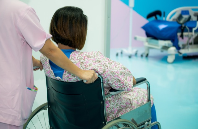 Nurse transfer pregnant woman by wheelchair to labor room, Nurse pushing wheelchair with female patient pregnant to labor room of hospital corridor,Pregnant woman active labor by natural, Health care