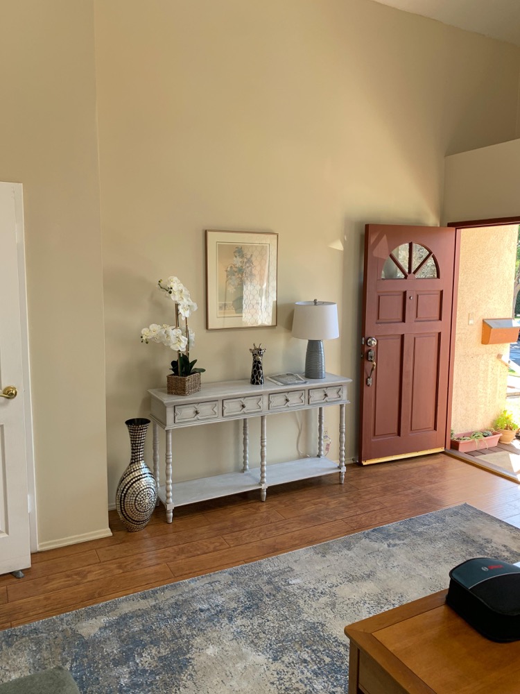 Entry foyer and console table with orchid arrangement