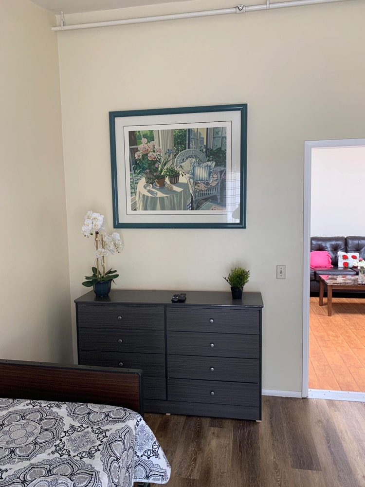 Resident bedroom with view through doorway into living lounge