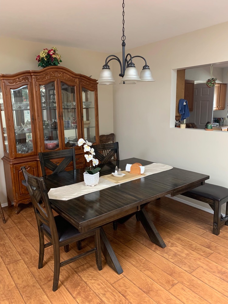 Family dining room with hardwood table and traditional china cabinet