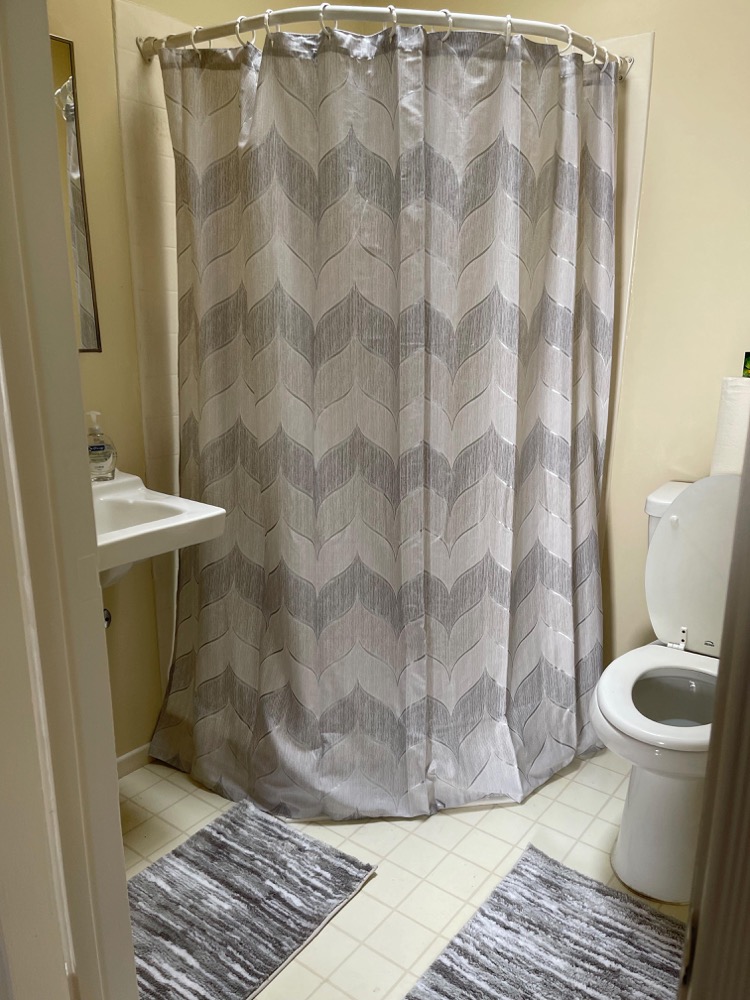 Clean resident bathroom with shower and vanity on Military Ave